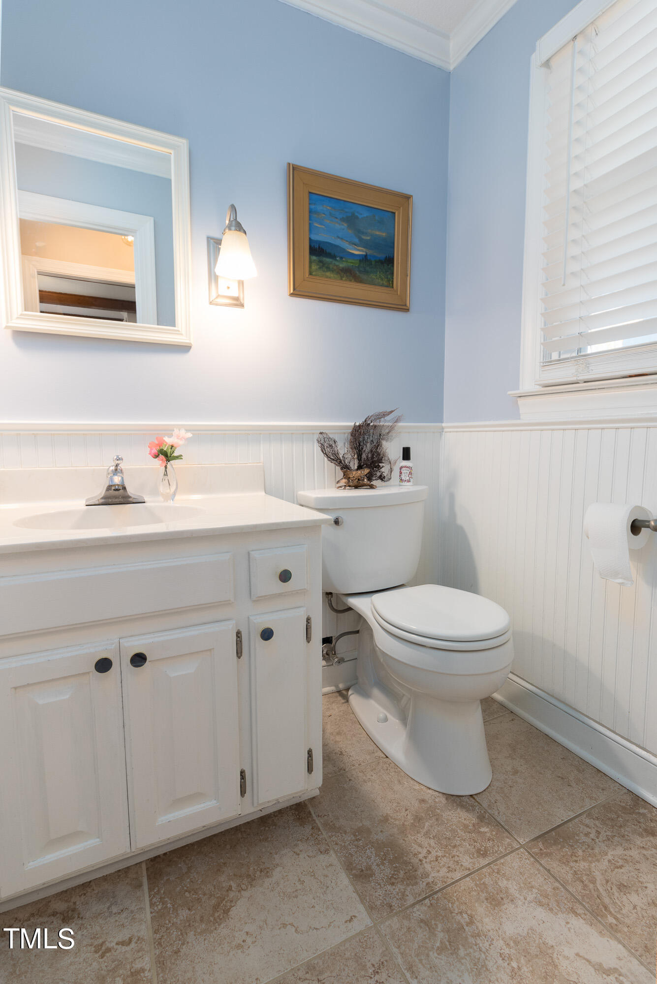8832 Campfire Trail Raleigh, NC 27615 - Photo 8 of 19 a white toilet sitting next to a bathroom sink
