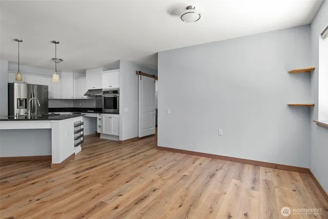 a kitchen with stainless steel appliances a refrigerator and a stove top oven