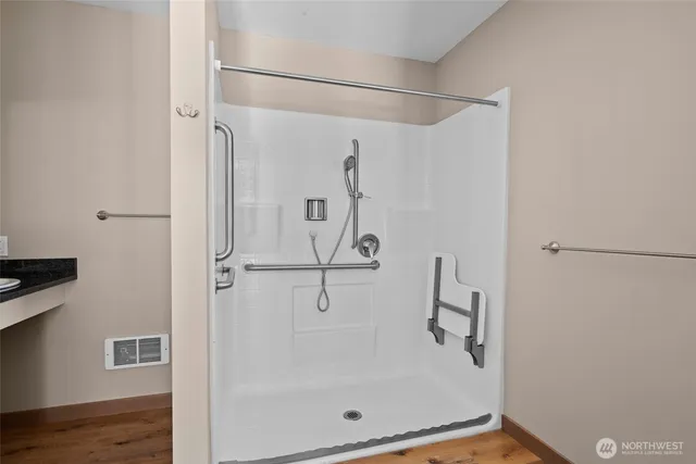 a bathroom with a glass shower door