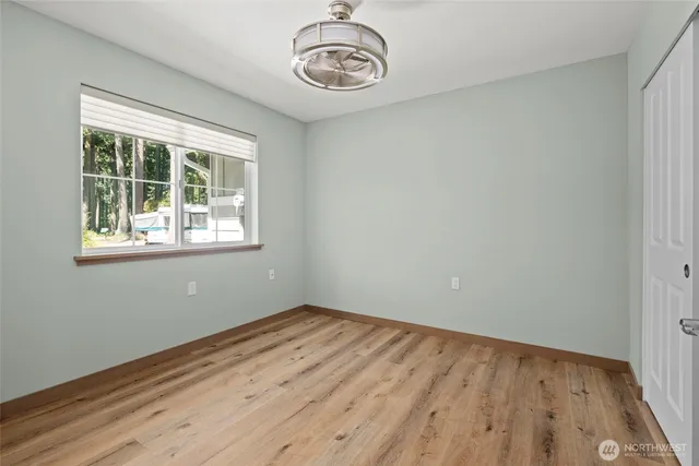 a view of a room with wooden floor and windows