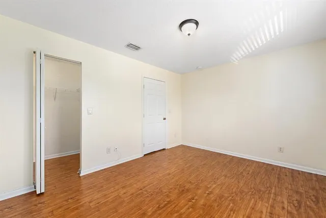 a view of a room with wooden floor