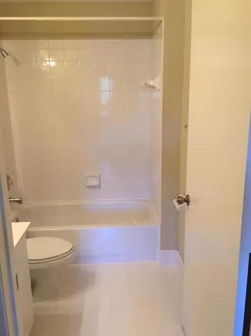 a bathroom with a shower and a toilet