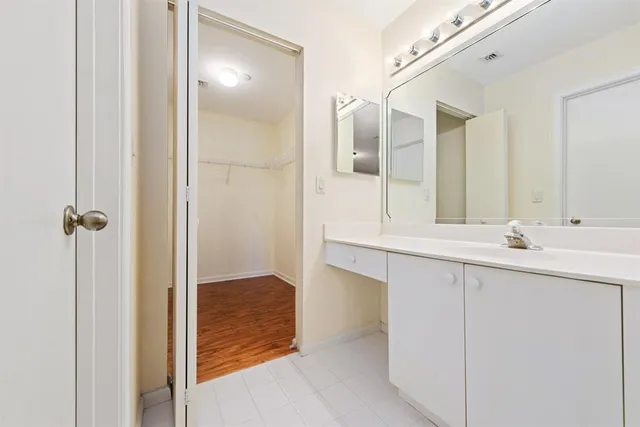 a bathroom with a double vanity sink and mirror