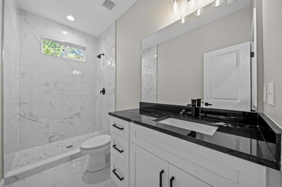 105 Bree Drive Anderson, SC 29621 - Photo 30 of 48 A sleek white vanity and dark countertop define this modern bathroom with a spacious walk-in shower.