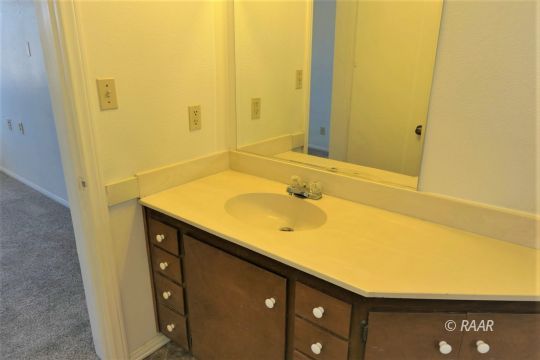 229 North Helena Street Ridgecrest, CA 93555 - Photo 16 of 32 a bathroom with a sink and a mirror