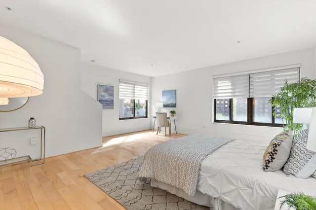 a bedroom with a large bed and a window