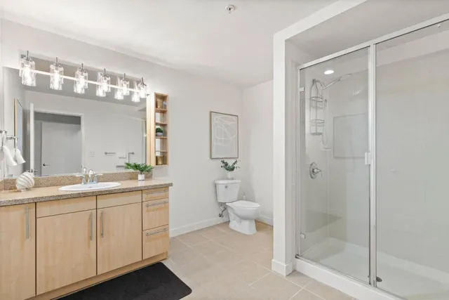 a spacious bathroom with a granite countertop sink mirror and toilet