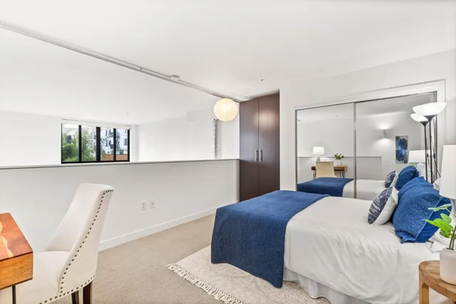 a bedroom with a bed and a lamp on table