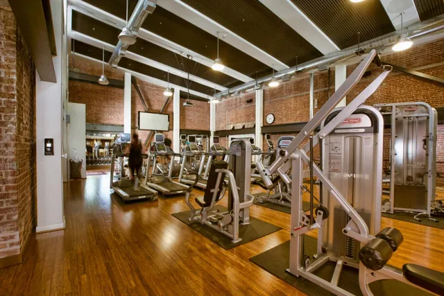 a room with pool table flat screen tv and windows