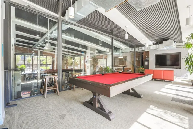 a dining hall with stainless steel appliances kitchen island granite countertop furniture and a fireplace