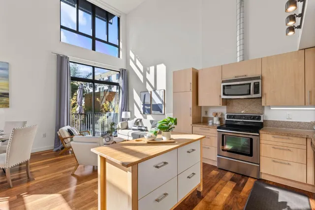 a kitchen with stainless steel appliances granite countertop a stove a sink and a microwave