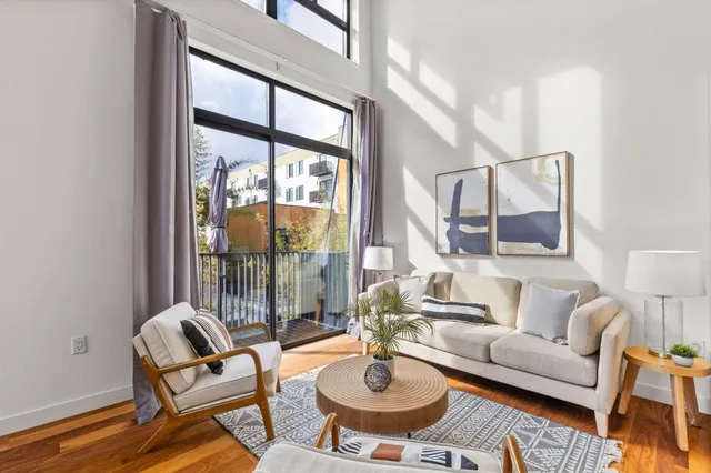 a living room with furniture and a potted plant