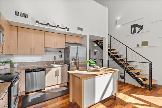 a kitchen with appliances cabinets and furniture