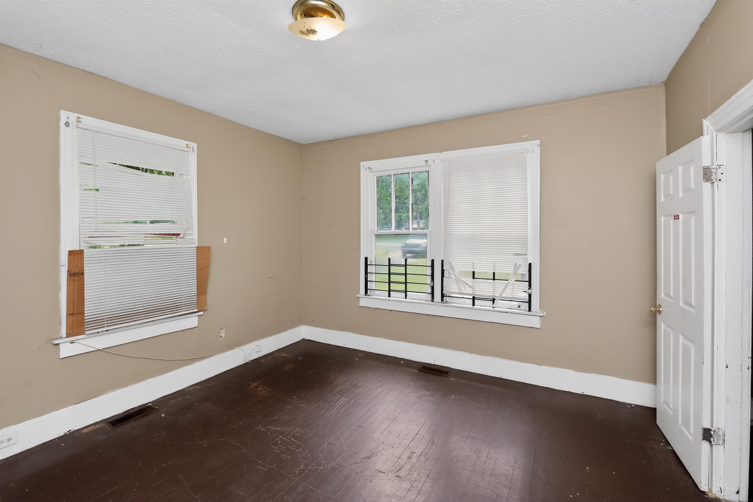810 Hale Road Memphis, TN 38116 - Photo 11 of 30 Interior room featuring wood-finish flooring, two windows with white blinds, and a white paneled door