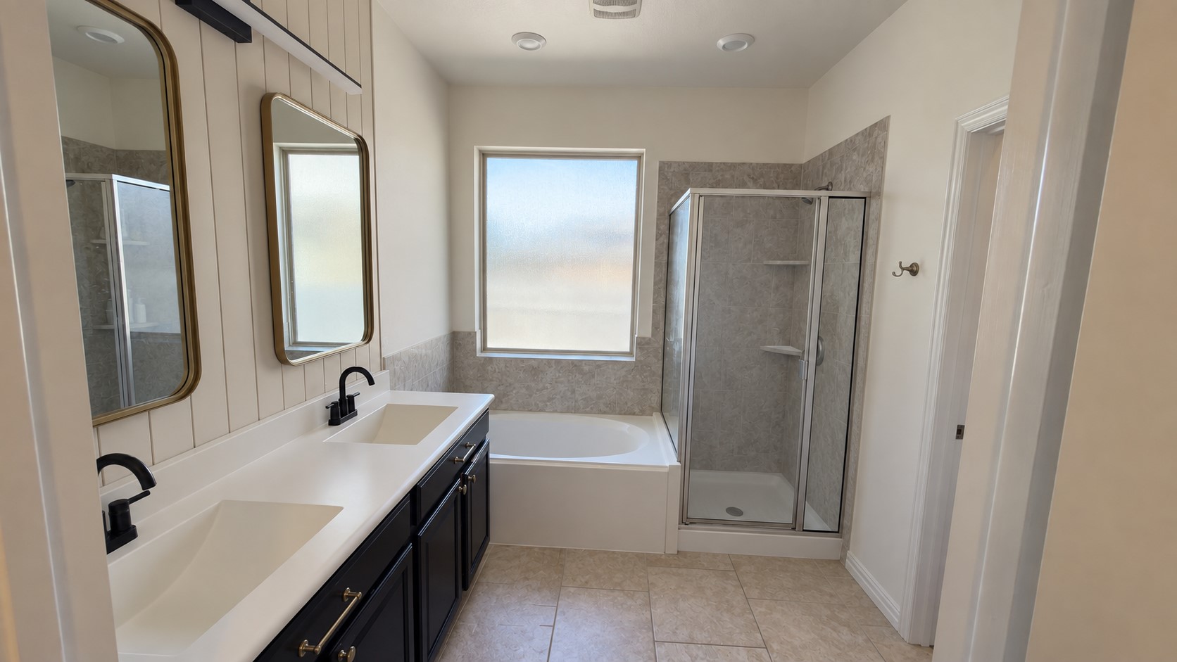 2500 Rough Berry Road Pflugerville, TX 78660 - Photo 8 of 15 Tile flooring and a dual vanity with dark cabinetry complement the separate tub and shower.