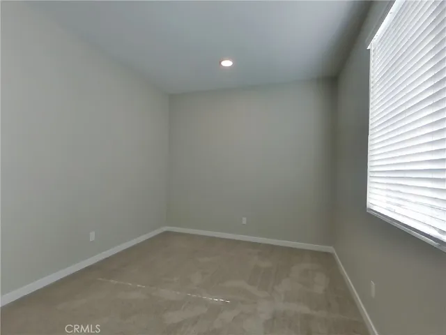 a view of an empty room and a window