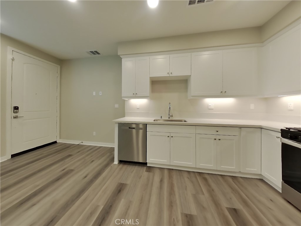 24944 Siempre Court Wildomar, CA 92595 - Photo 14 of 31 a kitchen with a sink and cabinets
