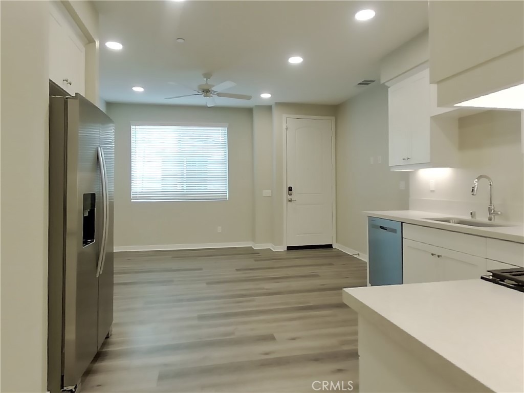 24944 Siempre Court Wildomar, CA 92595 - Photo 15 of 31 a view of kitchen with granite countertop cabinets and refrigerator