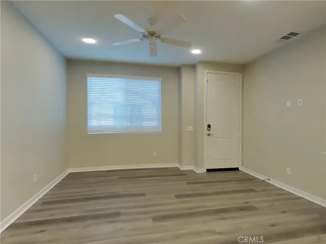 a view of wooden floor and windows in a room