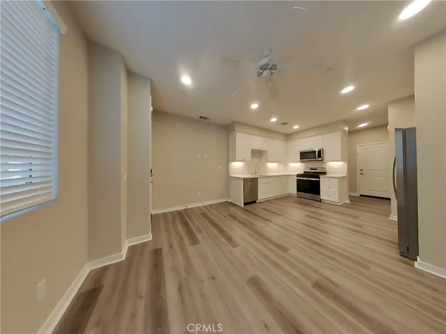 a view of kitchen and kitchen with furniture wooden floor