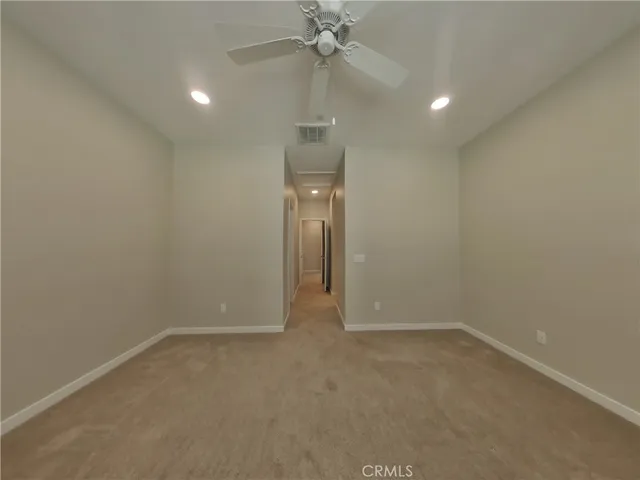 an empty room and chandelier fan in a room