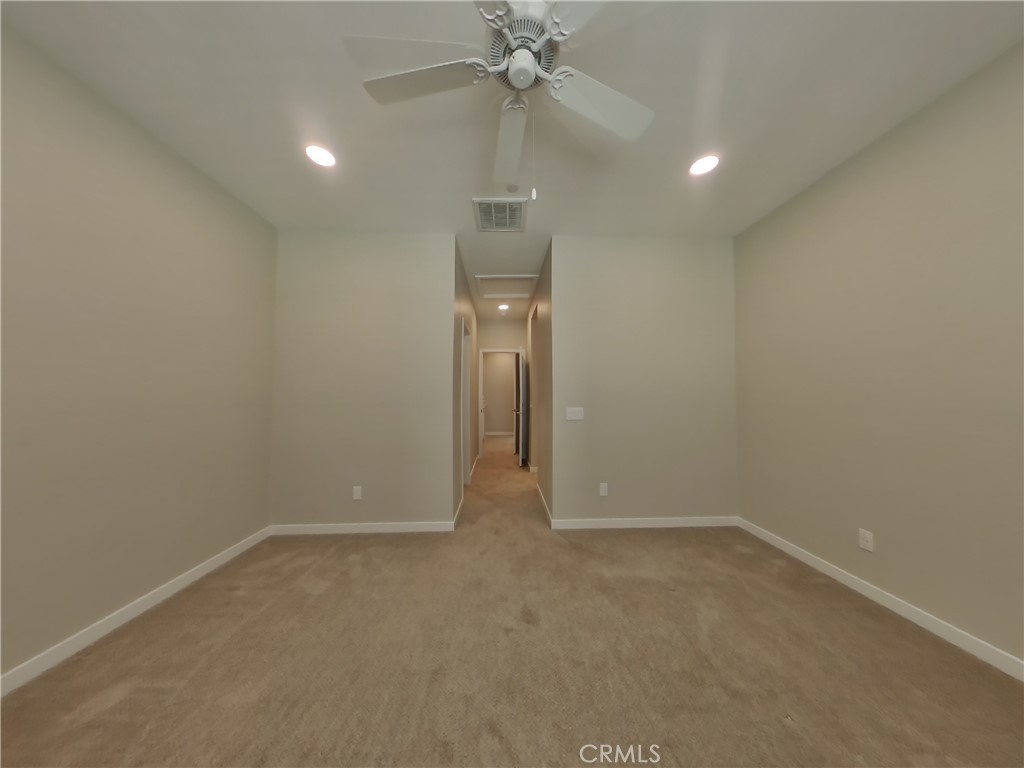 24944 Siempre Court Wildomar, CA 92595 - Photo 7 of 31 an empty room and chandelier fan in a room