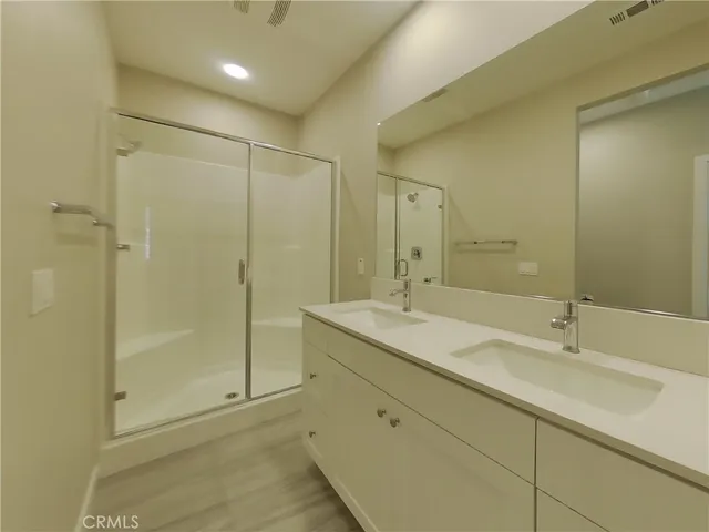 a bathroom with a shower sink and mirror