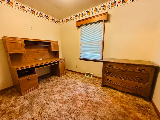 a view of room with window and furniture