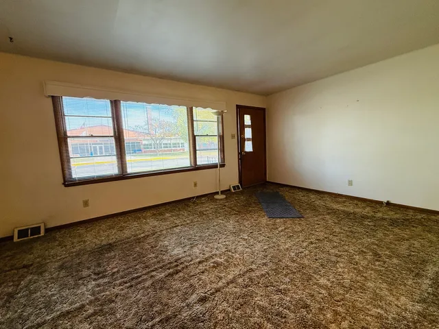 an empty room with a empty space and windows