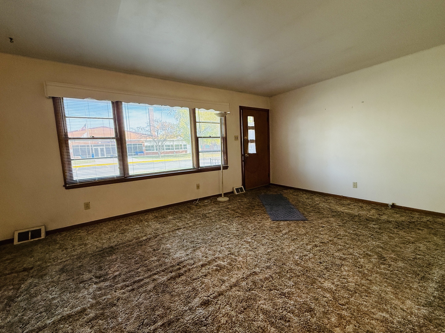 306 7th Street Cornell, IL 61319 - Photo 3 of 17 an empty room with a empty space and windows
