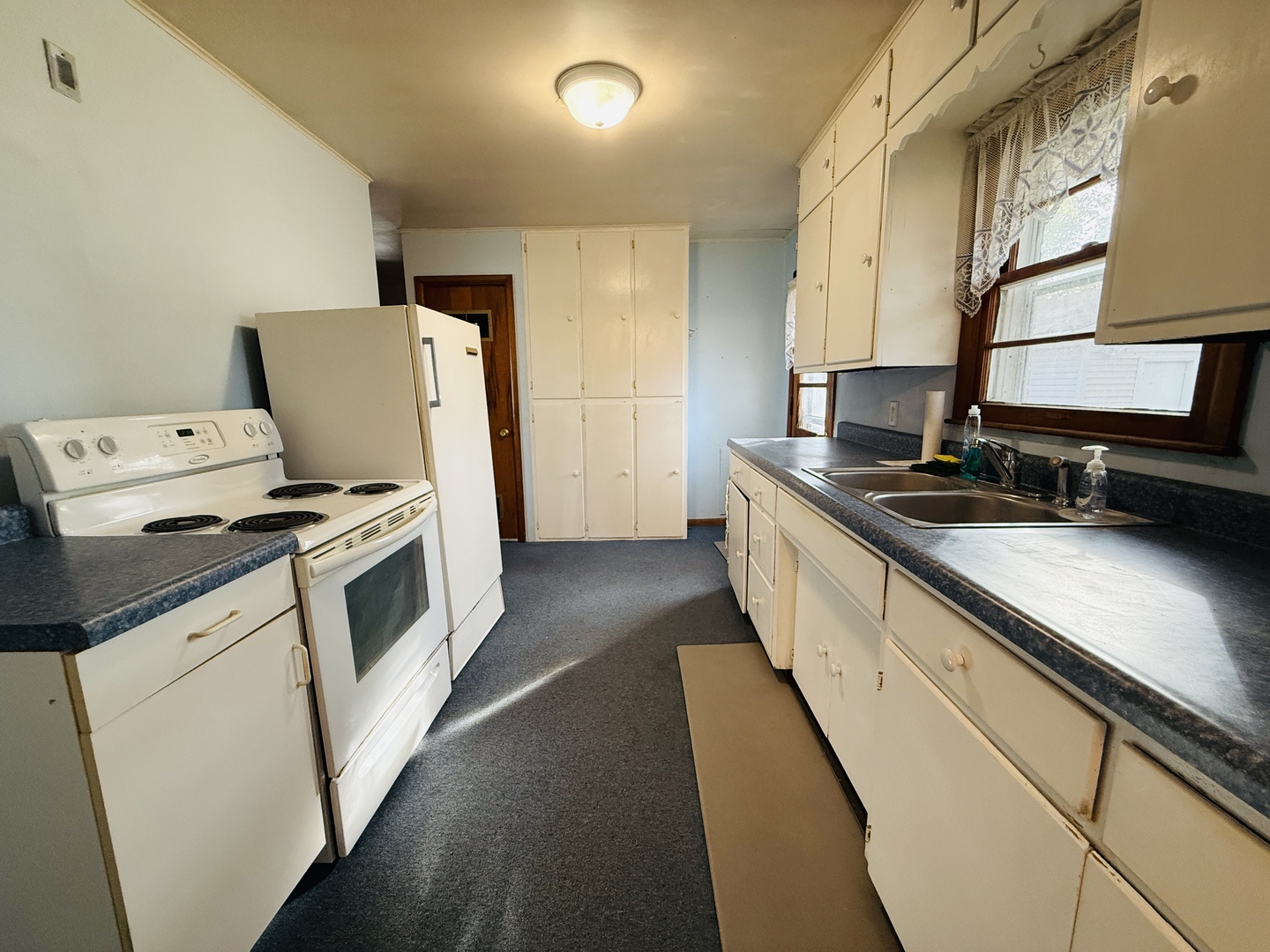 306 7th Street Cornell, IL 61319 - Photo 5 of 17 a kitchen with granite countertop a sink a stove and washer