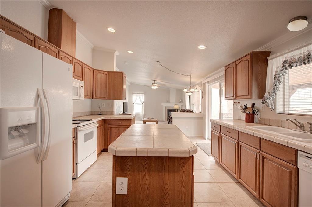 6186 Ranch Road Hartsel, CO 80449 - Photo 12 of 30 a kitchen with stainless steel appliances granite countertop a sink stove and refrigerator