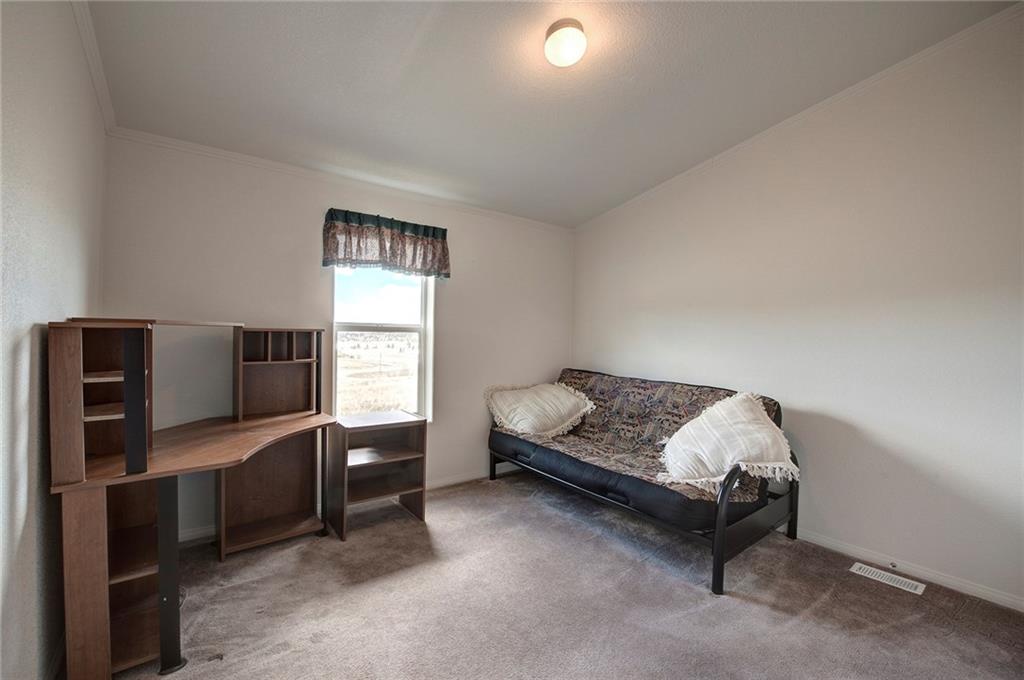 6186 Ranch Road Hartsel, CO 80449 - Photo 24 of 30 a bedroom with furniture and a flat screen tv
