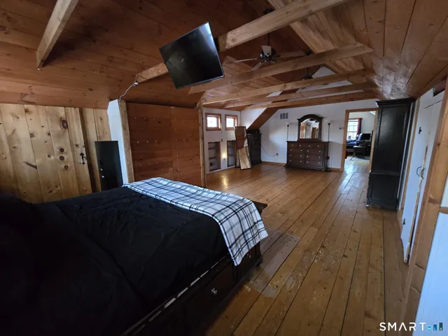 a spacious bedroom with a bed and a large window