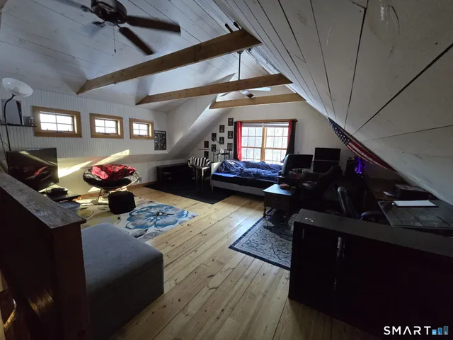 a living room with furniture fireplace and a window