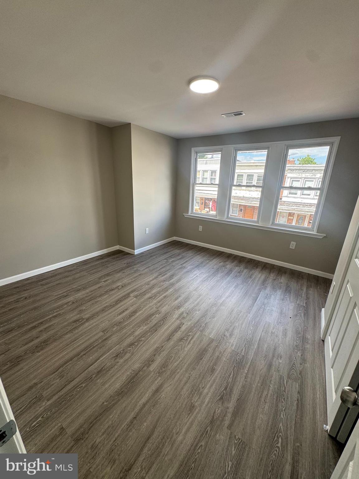 6018 Ross Street Philadelphia, PA 19144 - Photo 6 of 14 an empty room with wooden floor and windows