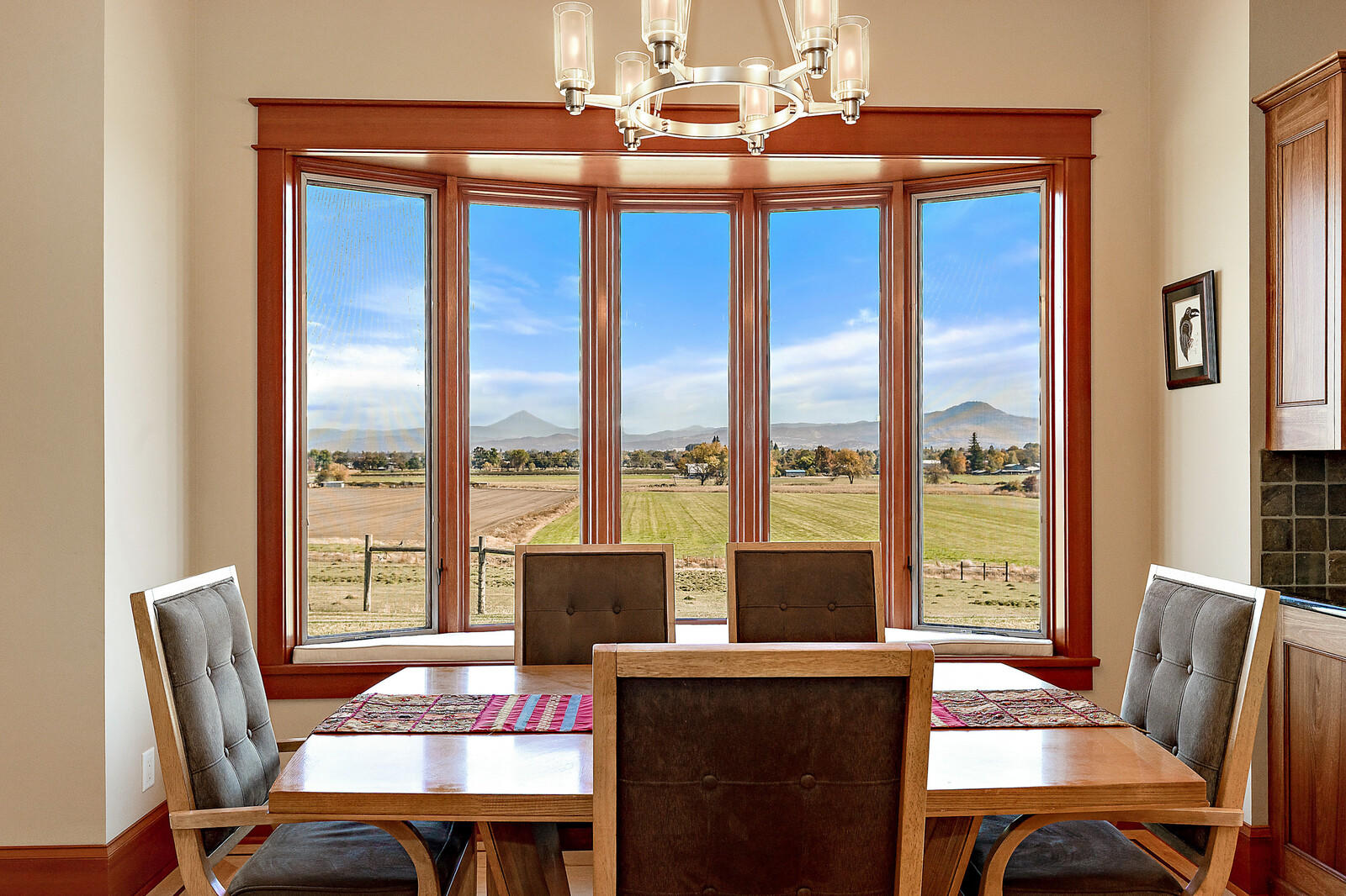 5405-5413 Seven Oaks Road Central Point, OR 97502 - Photo 21 of 65 a dining room with furniture a chandelier and large windows