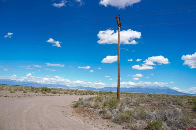 a view of a building with a floor to ceiling window and a ceiling fan