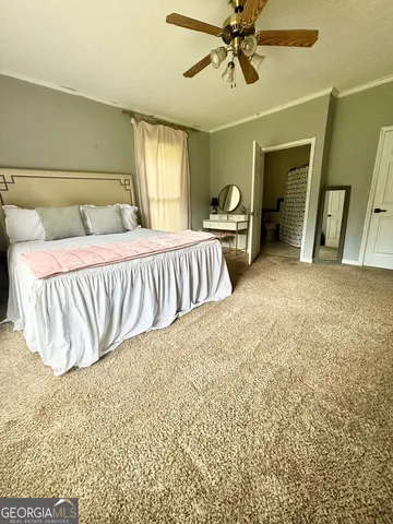 a spacious bedroom with a bed and a chandelier
