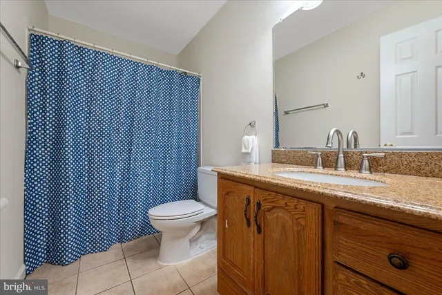 a bathroom with a sink toilet and a mirror