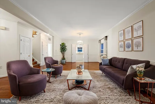 a living room with furniture or couch and a wooden floor