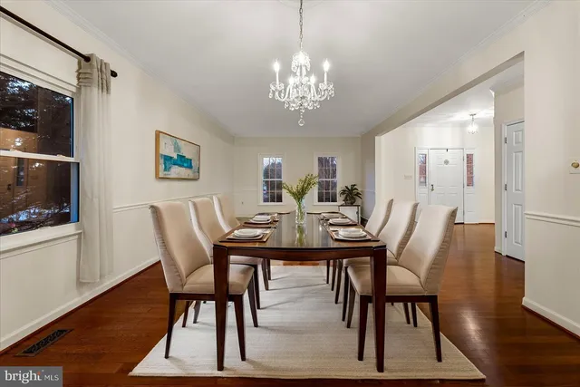 a view of a dining room with furniture wooden floor and chandelier