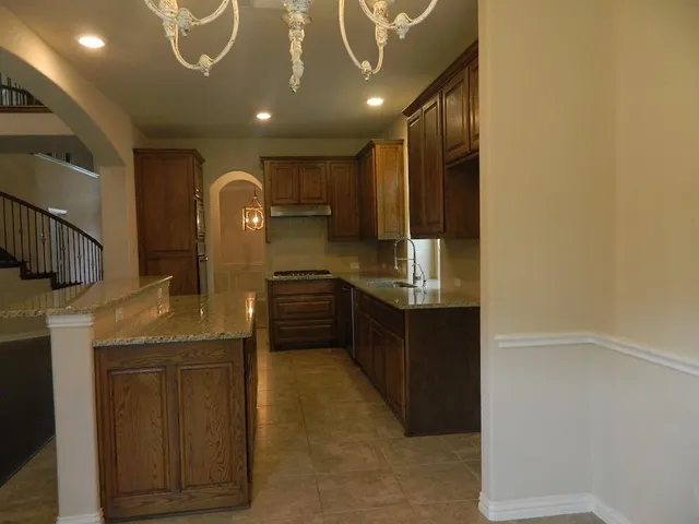 a kitchen with stainless steel appliances granite countertop a sink and cabinets