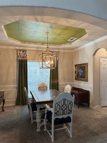 a dining room with furniture and window