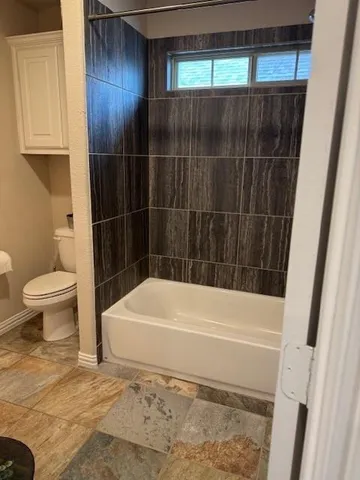 a bathroom with a shower and a toilet