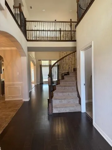 a view of entryway and hall with wooden floor
