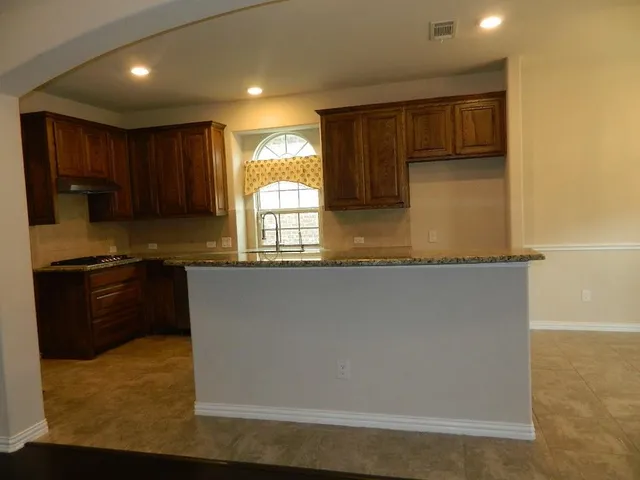 a kitchen with granite countertop white cabinets and a granite counter tops