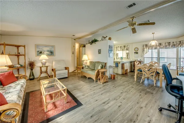 a living room with lots of furniture and a wooden floor
