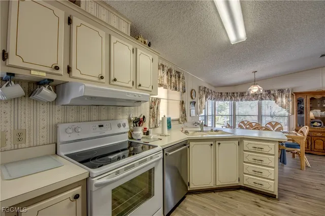 a kitchen with a stove a sink and a microwave