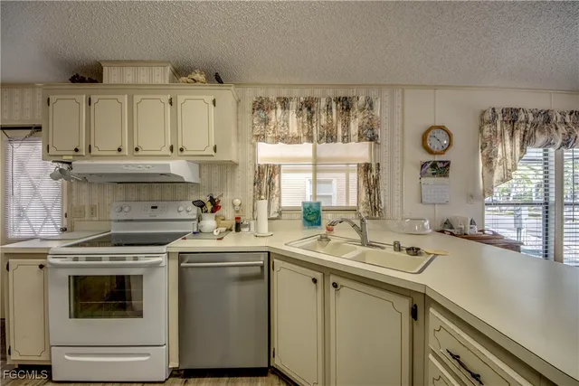 a kitchen with a sink stove and cabinets